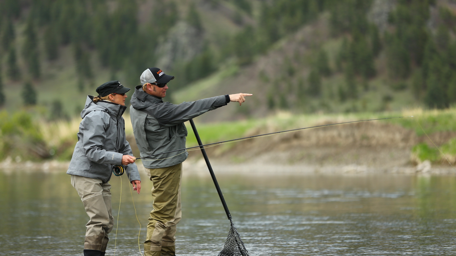 A fly fishing guide guiding a client